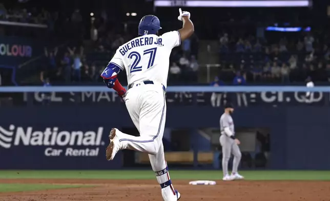 Toronto Blue Jays' Vladimir Guerrero Jr (27) runs the bases after hitting a two-run home run against the Boston Red Sox in the third inning of a baseball game in Toronto on Tuesday, April 29, 2025. (Jon Blacker/The Canadian Press via AP)