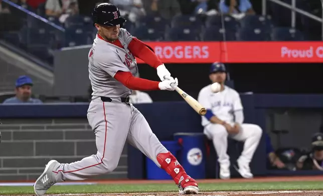 Boston Red Sox third baseman Alex Bregman (2) hits a solo home run against the Toronto Blue Jays in first inning MLB action in Toronto on Tuesday, April 29, 2025. (Jon Blacker/The Canadian Press via AP)