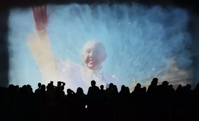 A portrait of the late Pope Francis is projected onto a water fountain at Magic Water Circuit in Lima, Peru, Monday, April 21, 2025. (AP Photo/Martin Mejia)