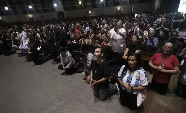 Worshippers pray for Pope Francis during a Mass following the announcement of his death at the Cathedral in Rio de Janeiro, Brazil, Monday, April 21, 2025.(AP Photo/Bruna Prado)