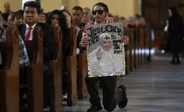 Emerson Espinosa prays during a Mass in tribute to the late Pope Francis at the Cathedral in Bogotá, Colombia, Monday, April 21, 2025. (AP Photo/Fernando Vergara)