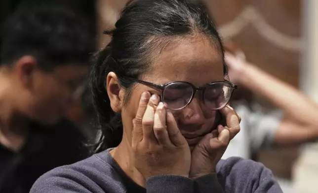 A woman wipes tears from her face during a mass at the the Church of Our Lady of the Assumption which Pope Francis visited in 2024, in Jakarta, Indonesia, Monday, April 21, 2025. (AP Photo/Achmad Ibrahim)