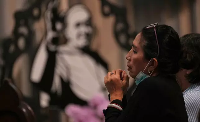 A woman prays during a mass at the Church of Our Lady of the Assumption which visited Pope Francis visited in 2024, in Jakarta, Indonesia, Monday, April 21, 2025. (AP Photo/Achmad Ibrahim)