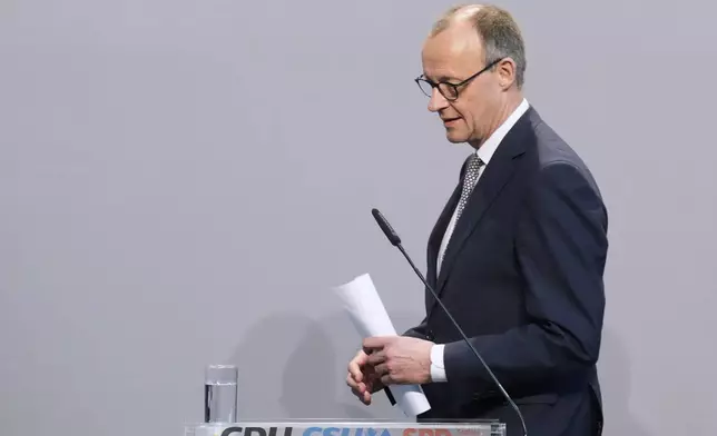 Friedrich Merz, Christian Democratic Union party chairman, arrives before addressing the media after reaching an agreement between their parties on a coalition for a new German government at a news conference in Berlin, Germany, Wednesday, April 9, 2025. (AP Photo/Ebrahim Noroozi)