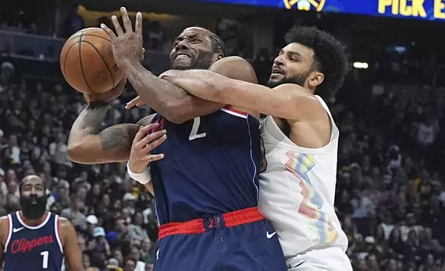 Los Angeles Clippers forward Kawhi Leonard (2) is fouled by Denver Nuggets guard Jamal Murray in the second half of Game 5 of an NBA basketball playoff series Tuesday, April 29, 2025, in Denver. (AP Photo/David Zalubowski)