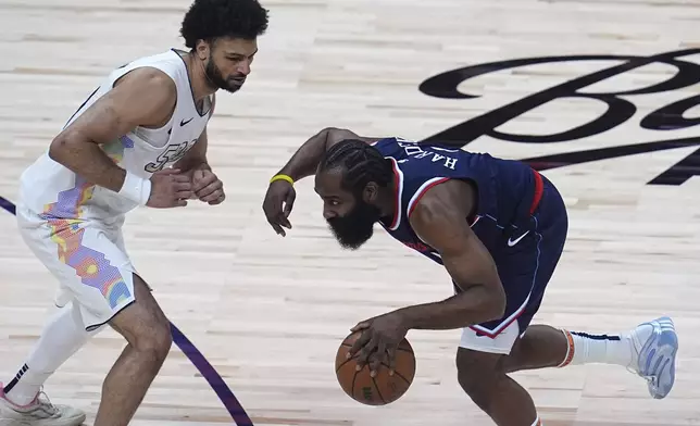 Los Angeles Clippers guard James Harden, right, collects a loose ball as Denver Nuggets guard Jamal Murray defends in the first half of Game 5 of an NBA basketball playoff series Tuesday, April 29, 2025, in Denver. (AP Photo/David Zalubowski)