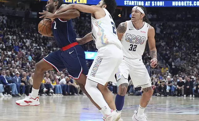 Los Angeles Clippers forward Kawhi Leonard, left, is fouled by Denver Nuggets guard Jamal Murray as forward Aaron Gordon (32) looks on in the second half of Game 5 of an NBA basketball playoff series Tuesday, April 29, 2025, in Denver. (AP Photo/David Zalubowski)