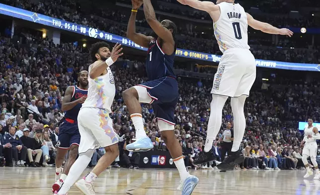 Los Angeles Clippers guard James Harden, center, drives to the basket between Denver Nuggets guards Jamal Murray, left, and Christian Braun (0) in the second half of Game 5 of an NBA basketball playoff series Tuesday, April 29, 2025, in Denver. (AP Photo/David Zalubowski)