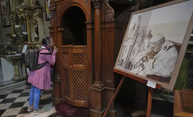 Alejandra Zuccoli prays at the Basílica de San José de Flores, the church where the late Pope Francis worshipped as a youth, following the Vatican's announcement of his death in Buenos Aires, Argentina, Monday, April 21, 2025. (AP Photo/Rodrigo Abd)