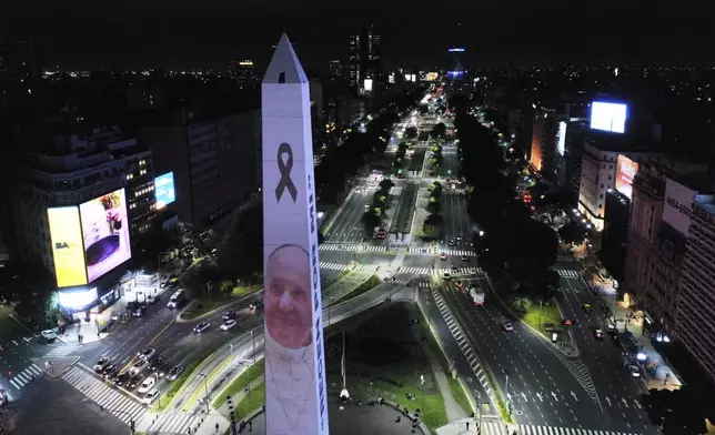 A photo of the late Pope Francis is projected onto the Obelisk in Buenos Aires, Argentina, Monday, April 21, 2025. (AP Photo/Gustavo Garello)
