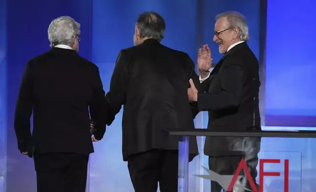 Filmmakers George Lucas, left, Francis Ford Coppola, center, and Steven Spielberg leave the stage together at the close of the 50th AFI Life Achievement Award tribute to Coppola on Saturday, April 26, 2025, at the Dolby Theatre in Los Angeles. (AP Photo/Chris Pizzello)
