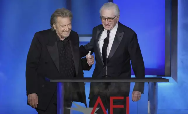 Actors Al Pacino, left, and Robert De Niro arrive onstage during the 50th AFI Life Achievement Award tribute to Francis Ford Coppola on Saturday, April 26, 2025, at the Dolby Theatre in Los Angeles. (AP Photo/Chris Pizzello)