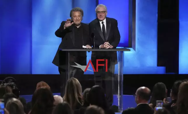 Actors Al Pacino, left, and Robert De Niro get a standing ovation during the 50th AFI Life Achievement Award tribute to Francis Ford Coppola on Saturday, April 26, 2025, at the Dolby Theatre in Los Angeles. (AP Photo/Chris Pizzello)