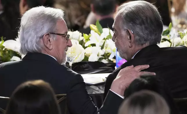 Filmmakers Steven Spielberg, left, and Francis Ford Coppola mingle during the 50th AFI Life Achievement Award tribute to Coppola on Saturday, April 26, 2025, at the Dolby Theatre in Los Angeles. (AP Photo/Chris Pizzello)