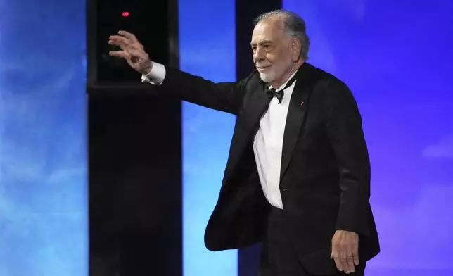 Filmmaker Francis Ford Coppola waves to the audience as he takes the stage during the 50th AFI Life Achievement Award tribute to Coppola on Saturday, April 26, 2025, at the Dolby Theatre in Los Angeles. (AP Photo/Chris Pizzello)