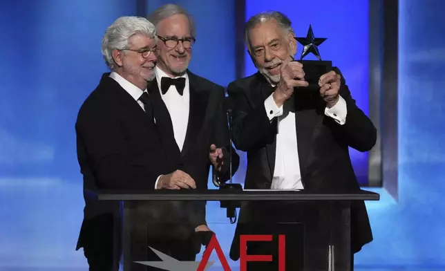 Filmmaker Francis Ford Coppola, right, accepts the 50th AFI Life Achievement Award from presenters George Lucas, left, and Steven Spielberg on Saturday, April 26, 2025, at the Dolby Theatre in Los Angeles. (AP Photo/Chris Pizzello)