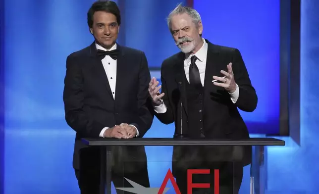 Actors Ralph Macchio, left, and C. Thomas Howell address the audience during the 50th AFI Life Achievement Award tribute to Francis Ford Coppola on Saturday, April 26, 2025, at the Dolby Theatre in Los Angeles. (AP Photo/Chris Pizzello)