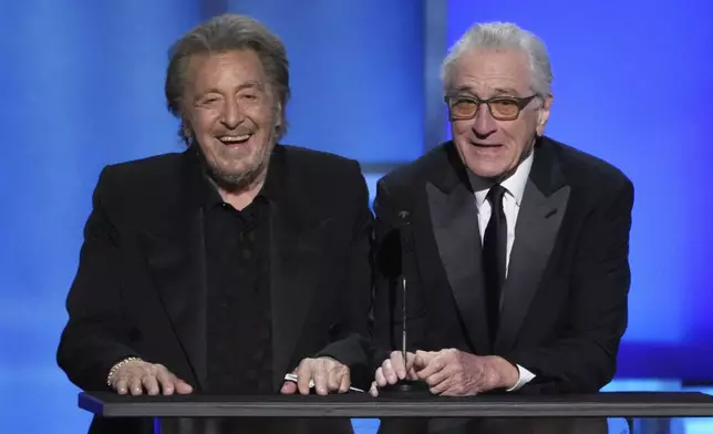 Actors Al Pacino, left, and Robert De Niro share a laugh onstage during the 50th AFI Life Achievement Award tribute to Francis Ford Coppola on Saturday, April 26, 2025, at the Dolby Theatre in Los Angeles. (AP Photo/Chris Pizzello)