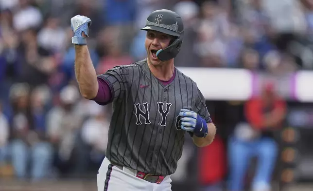 New York Mets' Pete Alonso gestures to teammates as he runs the bases after hitting a home run during the eighth inning of a baseball game against the St. Louis Cardinals Saturday, April 19, 2025, in New York. (AP Photo/Frank Franklin II)