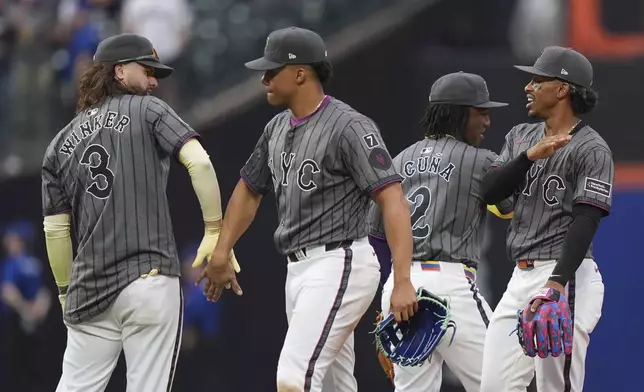 New York Mets' Jesse Winker, left, Juan Soto, Luisangel Acuña, second from left, and Francisco Lindor, right, celebrate after a baseball game against the St. Louis CardinalsSaturday, April 19, 2025, in New York. (AP Photo/Frank Franklin II)