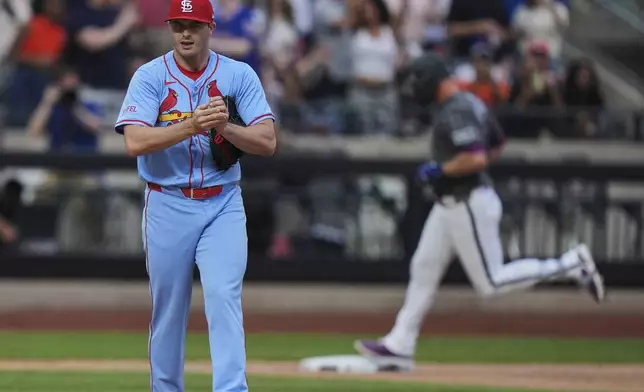 St. Louis Cardinals pitcher John King, left, reacts as New York Mets' Pete Alonso runs the bases after hitting a home run during the eighth inning of a baseball game Saturday, April 19, 2025, in New York. (AP Photo/Frank Franklin II)