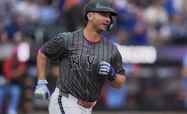 New York Mets' Pete Alonso smiles as he runs the bases after hitting a home run during the eighth inning of a baseball game against the St. Louis Cardinals Saturday, April 19, 2025, in New York. (AP Photo/Frank Franklin II)