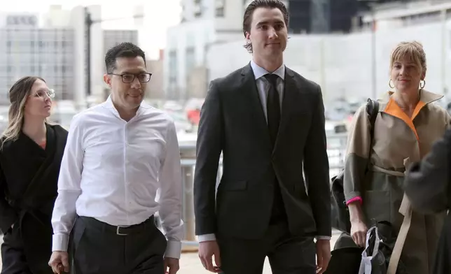 Alex Formenton, second from right, one of five members of Canada’s 2018 world junior hockey team charged with sexual assault last year for an incident that allegedly took place in June 2018, arrives at the London Courthouse in London, Ontario, Wednesday, April 23, 2025. (Nicole Osborne/The Canadian Press via AP)