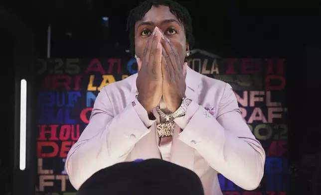 Georgia defensive back Malaki Starks reacts before on a hat after being chosen by the Baltimore Ravens with the 27th overall pick during the first round of the NFL football draft, Thursday, April 24, 2025, in Green Bay, Wis. (AP Photo/Jeff Roberson)
