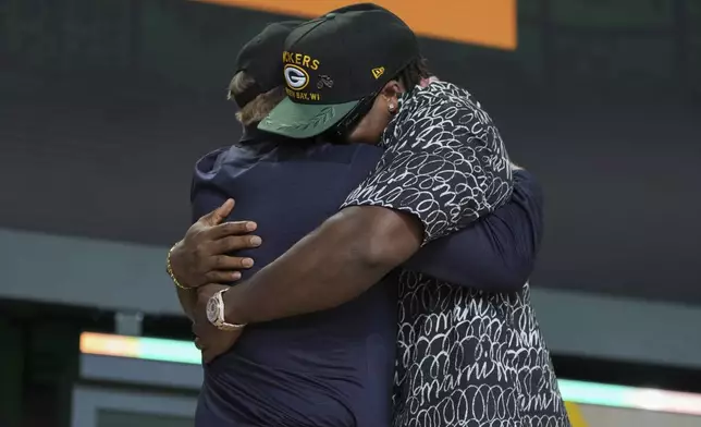 Texas defensive lineman Barryn Sorrell, right, embraces NFL Commissioner Roger Goodell after being chosen by the Green Bay Packers with the 124th overall pick during the third day of the NFL football draft, Saturday, April 26, 2025, in Green Bay, Wis. (AP Photo/Jeff Roberson)