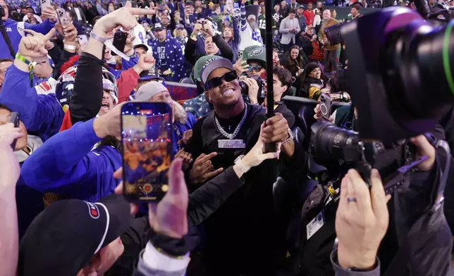 Penn State defensive end Abdul Carter celebrates with fans after being chosen by the New York Giants with the third overall pick during the first round of the NFL football draft, Thursday, April 24, 2025, in Green Bay, Wis. (AP Photo/Matt Ludtke)