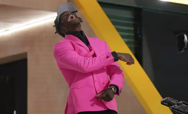 Colorado wide receiver Travis Hunter celebrates after being chosen by the Jacksonville Jaguars with the second overall pick during the first round of the NFL football draft, Thursday, April 24, 2025, in Green Bay, Wis. (AP Photo/Jeff Roberson)