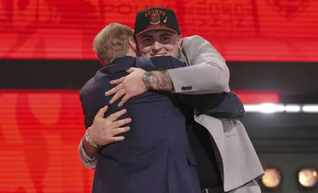 Michigan defensive lineman Mason Graham embraces NFL Commissioner Roger Goodell after being chosen by the Cleveland Browns with the fifth overall pick during the first round of the NFL football draft, Thursday, April 24, 2025, in Green Bay, Wis. (AP Photo/Jeff Roberson)
