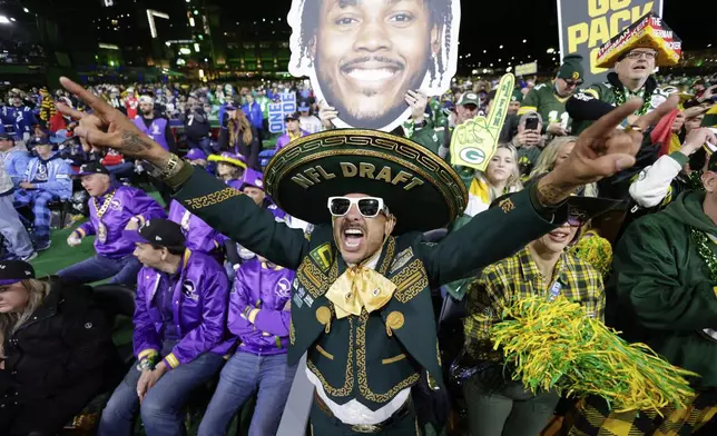 A Green Bay Packers fan celebrates during the third round of the NFL football draft, Friday, April 25, 2025, in Green Bay, Wis. (AP Photo/Matt Ludtke)