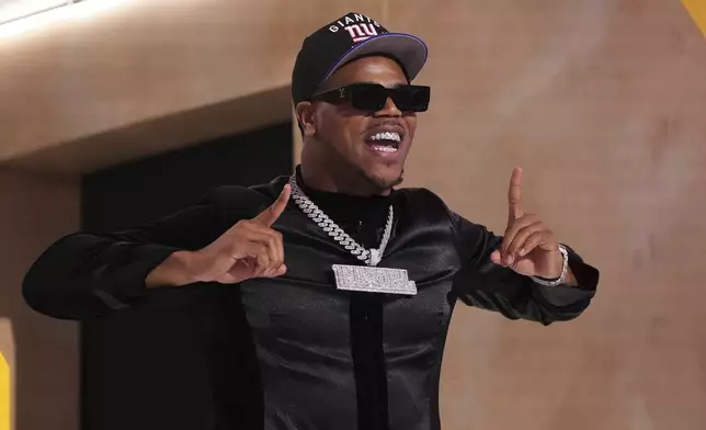 Penn State defensive end Abdul Carter celebrates after being chosen by the New York Giants with the third overall pick during the first round of the NFL football draft, Thursday, April 24, 2025, in Green Bay, Wis. (AP Photo/Jeff Roberson)