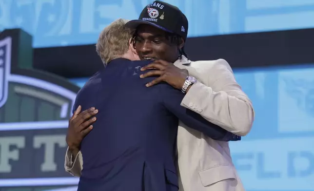 Miami quarterback Cam Ward, right, embraces NFL Commissioner Roger Goodell after being chosen by the Tennessee Titans with the first overall pick during the first round of the NFL football draft, Thursday, April 24, 2025, in Green Bay, Wis. (AP Photo/Matt Ludtke)