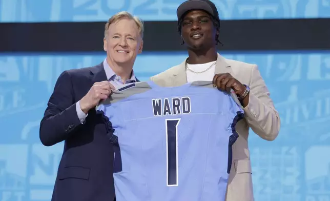 Miami quarterback Cam Ward, right, poses with NFL Commissioner Roger Goodell after being chosen by the Tennessee Titans with the first overall pick during the first round of the NFL football draft, Thursday, April 24, 2025, in Green Bay, Wis. (AP Photo/Matt Ludtke)