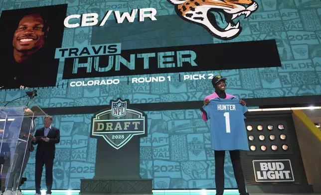 Colorado wide receiver Travis Hunter poses after being chosen by the Jacksonville Jaguars with the second overall pick during the first round of the NFL football draft, Thursday, April 24, 2025, in Green Bay, Wis. (AP Photo/Jeff Roberson)