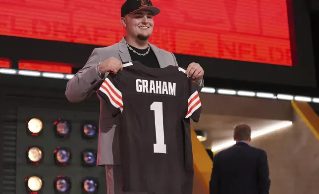 Michigan defensive lineman Mason Graham poses after being chosen by the Cleveland Browns with the fifth overall pick during the first round of the NFL football draft, Thursday, April 24, 2025, in Green Bay, Wis. (AP Photo/Jeff Roberson)