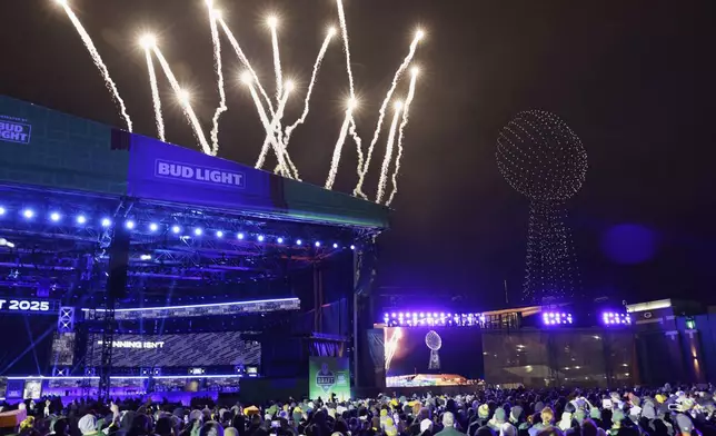Fans watch a firework and drone show after the third round of the NFL football draft, Friday, April 25, 2025, in Green Bay, Wis. (AP Photo/Matt Ludtke)