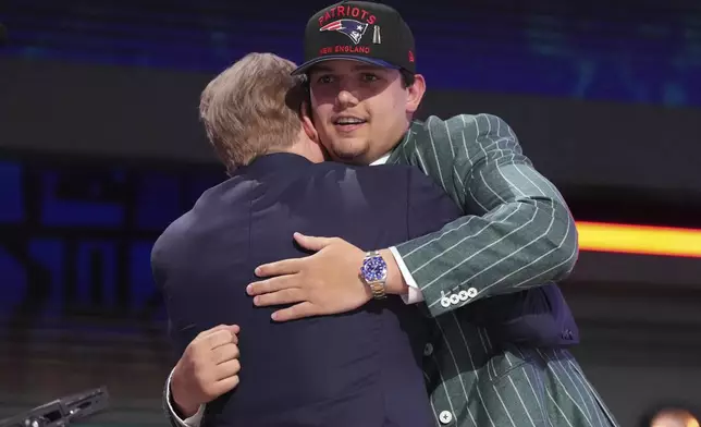 LSU offensive tackle Will Campbell, right, celebrates with NFL Commissioner Roger Goodell after being chosen by the New England Patriots with the fourth overall pick during the first round of the NFL football draft, Thursday, April 24, 2025, in Green Bay, Wis. (AP Photo/Jeff Roberson)