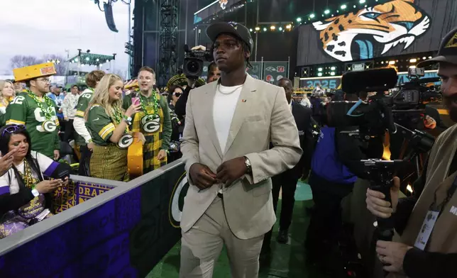Miami quarterback Cam Ward walks through the crowd after being chosen by the Tennessee Titans with the first overall pick during the first round of the NFL football draft, Thursday, April 24, 2025, in Green Bay, Wis. (AP Photo/Matt Ludtke)