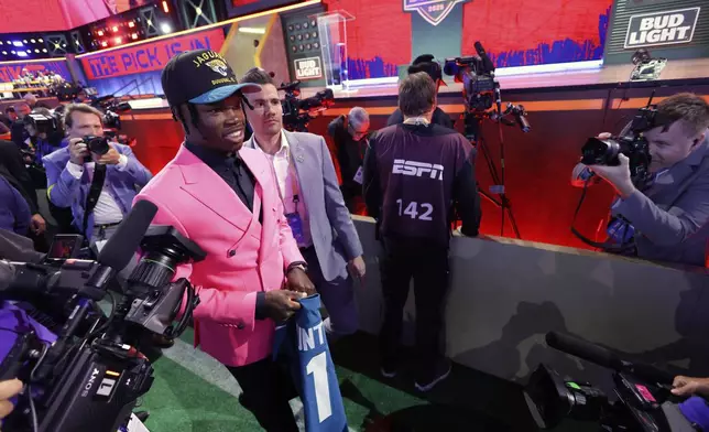 Colorado wide receiver Travis Hunter walks through the crowd after being chosen by the Jacksonville Jaguars with the second overall pick during the first round of the NFL football draft, Thursday, April 24, 2025, in Green Bay, Wis. (AP Photo/Matt Ludtke)