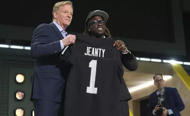 Boise State running back Ashton Jeanty, right, poses with NFL Commissioner Roger Goodell after being chosen by the Las Vegas Raiders with the sixth overall pick during the first round of the NFL football draft, Thursday, April 24, 2025, in Green Bay, Wis. (AP Photo/Jeff Roberson)