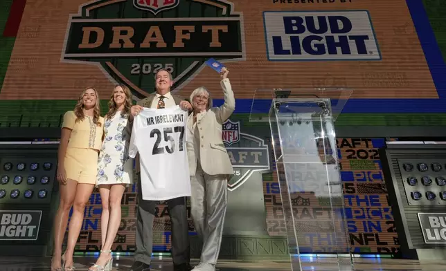 Melanie Salata Fitch, right, announces Memphis' Kobee Minor as the final pick by New England Patriots the during the third day of the NFL football draft, Saturday, April 26, 2025, in Green Bay, Wis. (AP Photo/Jeff Roberson)