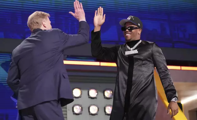 Penn State defensive end Abdul Carter, right, celebrates with NFL Commissioner Roger Goodell after being chosen by the New York Giants with the third overall pick during the first round of the NFL football draft, Thursday, April 24, 2025, in Green Bay, Wis. (AP Photo/Jeff Roberson)
