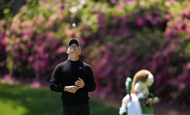 Rory McIlroy, of Northern Ireland, flips his ball on the 13th green during a practice round at the Masters golf tournament, Tuesday, April 8, 2025, in Augusta, Ga. (AP Photo/Julia Demaree Nikhinson)