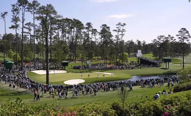 Golfers putt on the 16th hole during a practice around at the Masters golf tournament, Wednesday, April 9, 2025, in Augusta, Ga. (AP Photo/Ashley Landis)