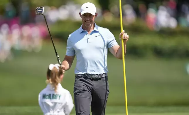 Rory McIlroy, of Northern Ireland, looks at his daughter, Poppy, on the first hole during the par-3 contest at the Masters golf tournament, Wednesday, April 9, 2025, in Augusta, Ga. (AP Photo/Ashley Landis)