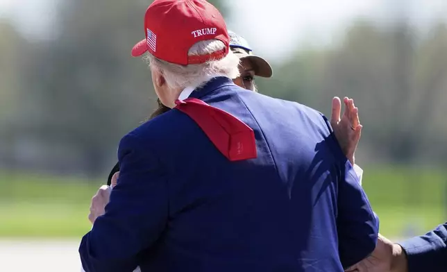 President Donald Trump greets Michigan Gov. Gretchen Whitmer as he arrives on Air Force One at Selfridge Air National Guard Base, Tuesday, April 29, 2025, in Harrison Township, Mich. (AP Photo/Alex Brandon)