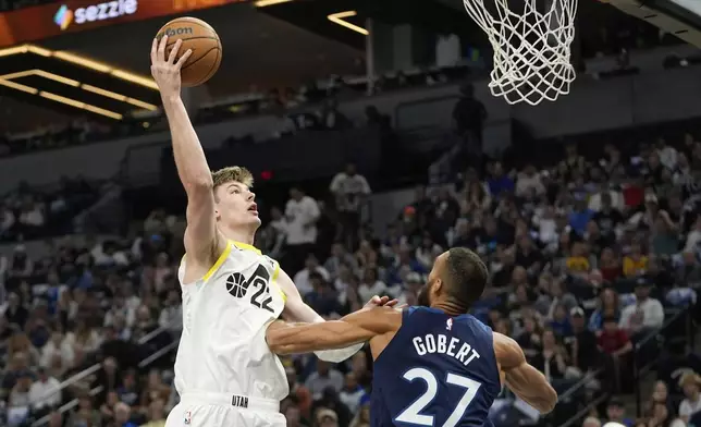 Utah Jazz forward Kyle Filipowski (22) shoots over Minnesota Timberwolves center Rudy Gobert (27) during the first half of an NBA basketball game, Sunday, April 13, 2025, in Minneapolis. (AP Photo/Abbie Parr)